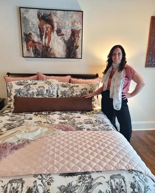 Crystal LeClair of Master Hand Construction Services in a finished bedroom