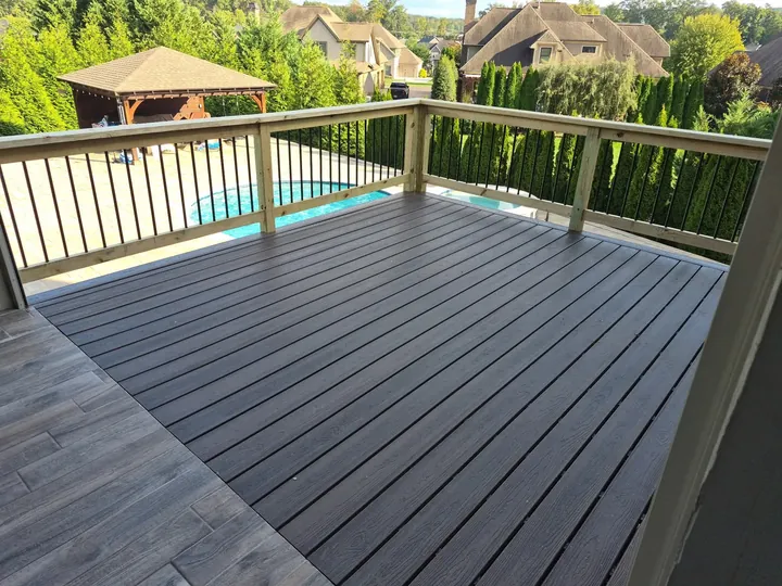 Composite deck with black balusters overlooking a pool in Farragut, TN