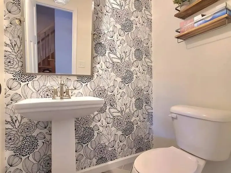 Powder room with botanical wallpaper and a pedestal basin