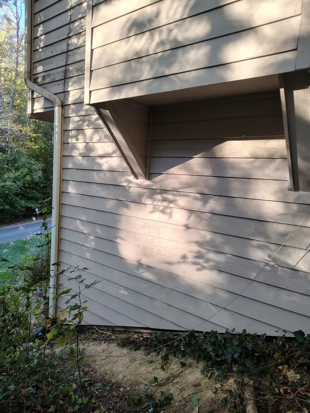 Repaired exterior wall with horizontal siding finished to match the surrounding area.